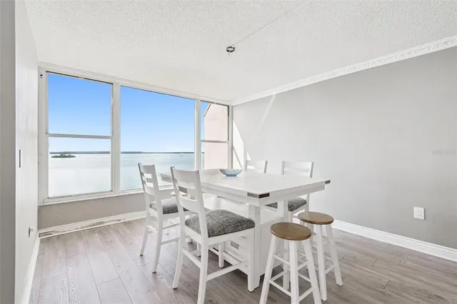 a kitchen with stainless steel appliances kitchen island granite countertop a refrigerator and cabinets
