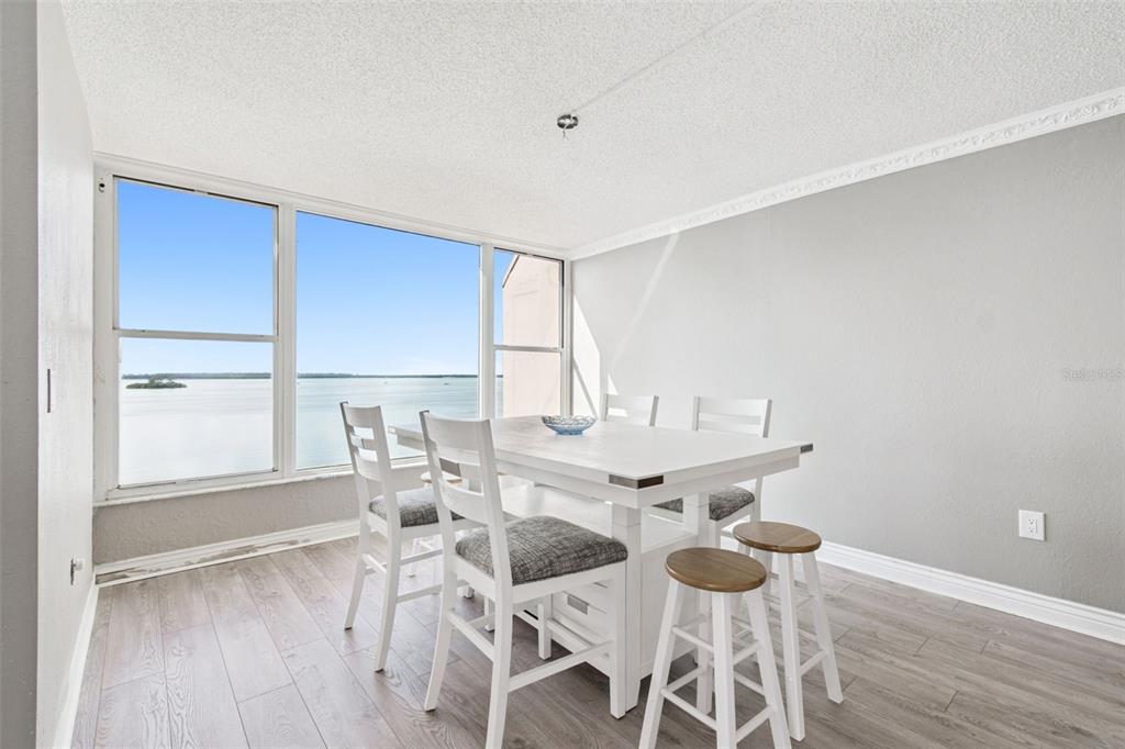634 Edgewater Drive, Unit 844 Dunedin, FL 34698 - Photo 6 of 68 a view of a dining room with furniture and wooden floor