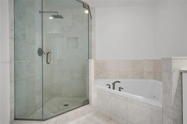 a bathroom with a bathtub and shower