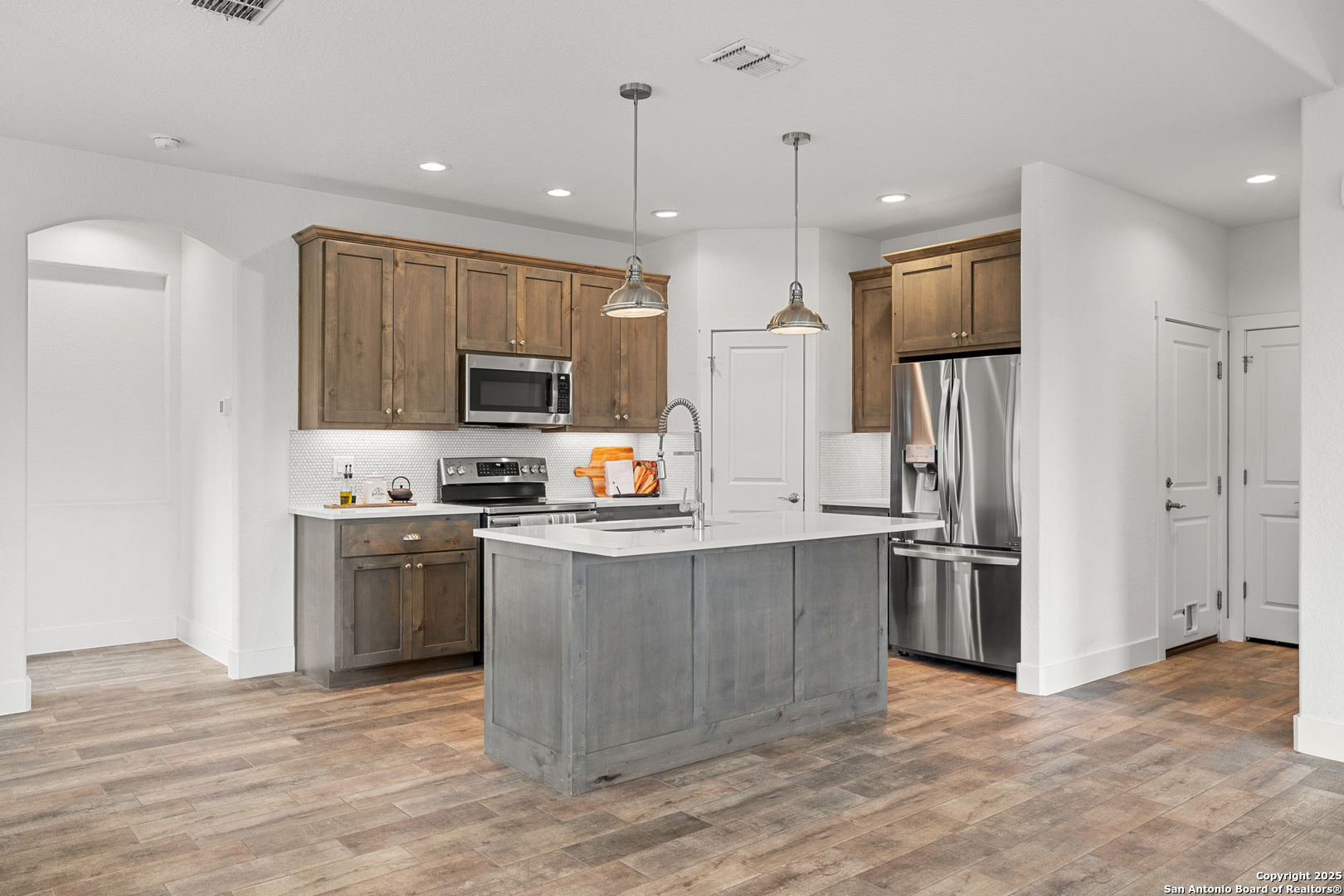 1039 Primrose Path Spring Branch, TX 78070 - Photo 11 of 30 a kitchen with stainless steel appliances granite countertop a refrigerator and a stove top oven