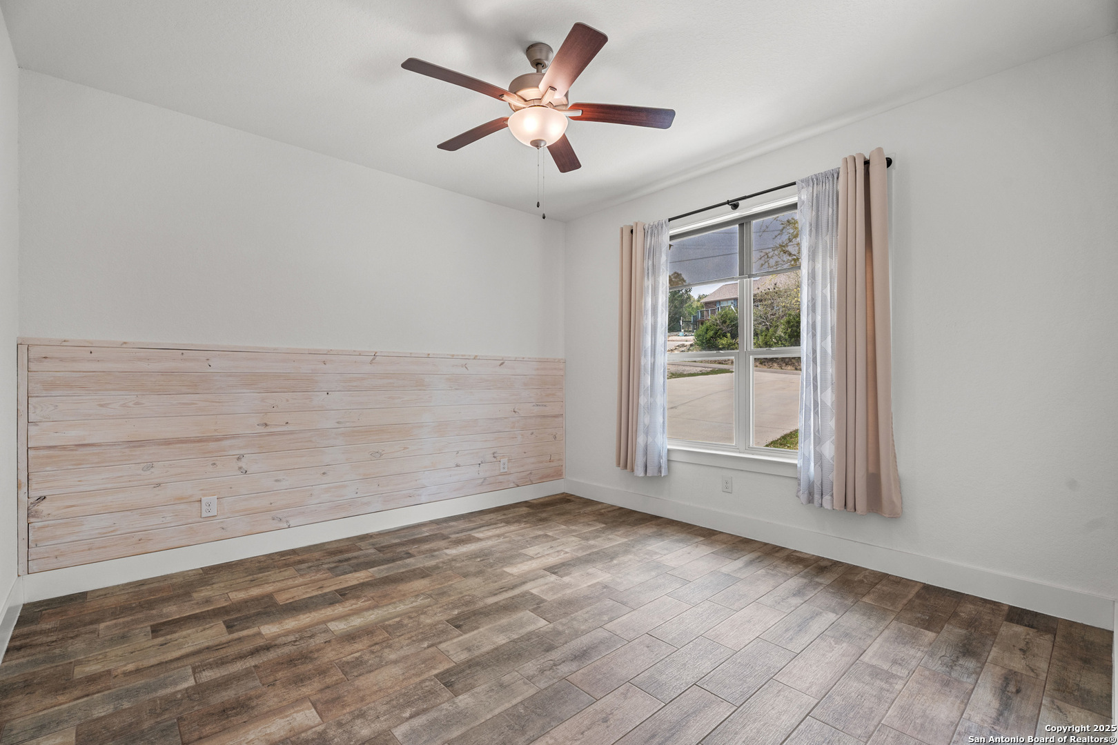 1039 Primrose Path Spring Branch, TX 78070 - Photo 19 of 30 an empty room with wooden floor and windows