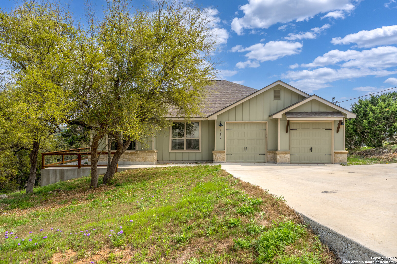 1039 Primrose Path Spring Branch, TX 78070 - Photo 2 of 30 a front view of a house with a garden