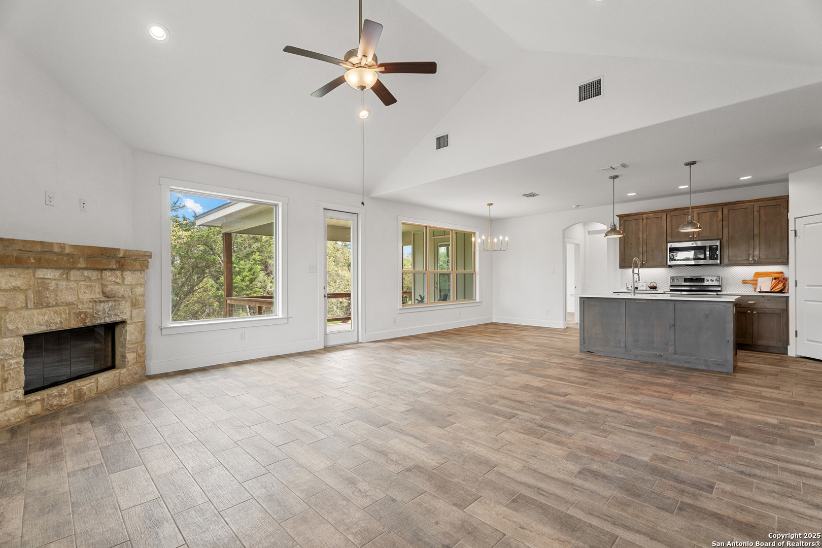 1039 Primrose Path Spring Branch, TX 78070 - Photo 7 of 30 a view of an empty room with a kitchen and a fireplace