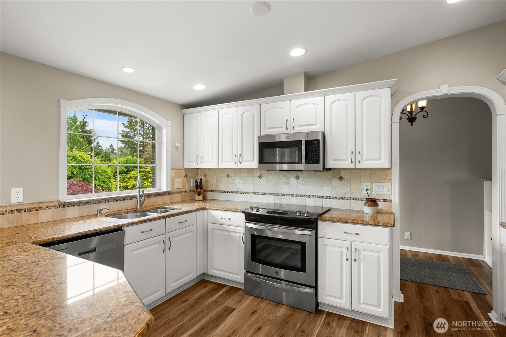 10 Jeffery Place Longview, WA 98632 - Photo 5 of 40 a kitchen with a sink white cabinets and white appliances
