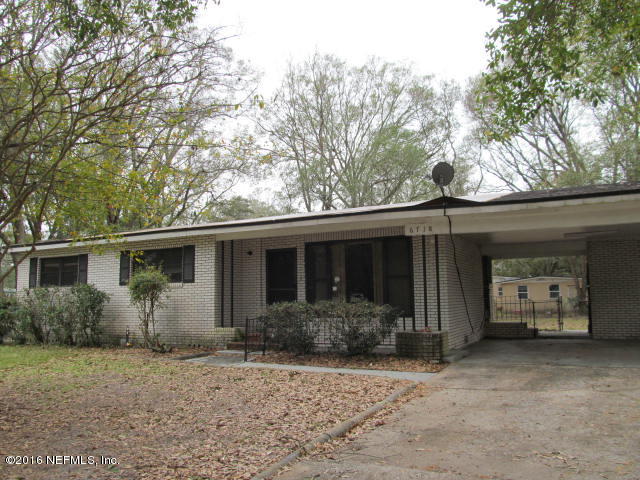 6718 Corday Road Jacksonville, FL 32208 - Photo 1 of 14 a house that has a tree in front of it