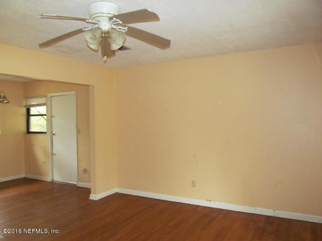 6718 Corday Road Jacksonville, FL 32208 - Photo 4 of 14 an empty room with a window and a fan