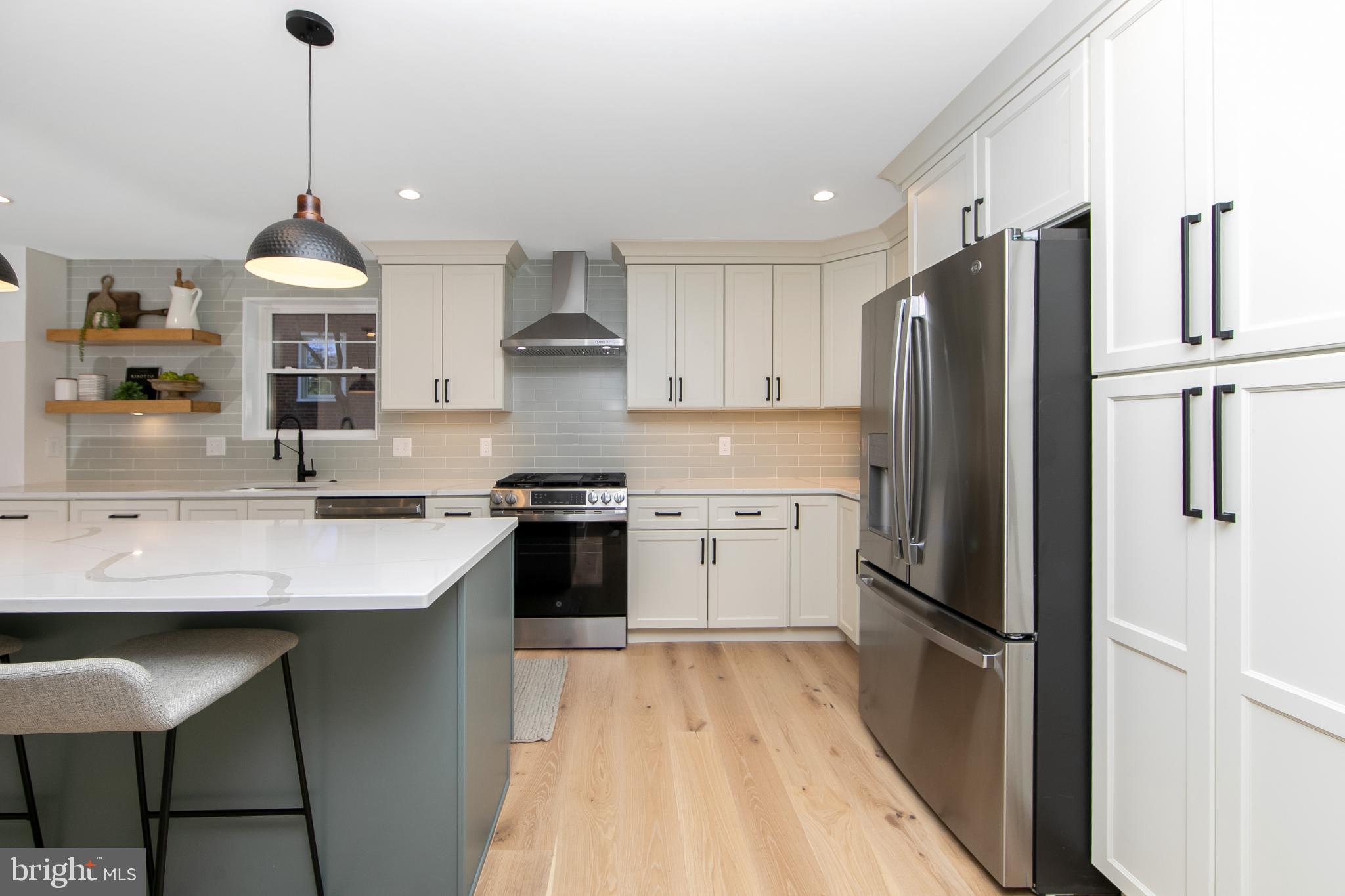 22 Scenic Road Springfield, PA 19064 - Photo 16 of 56 a kitchen with stainless steel appliances a sink stove and refrigerator