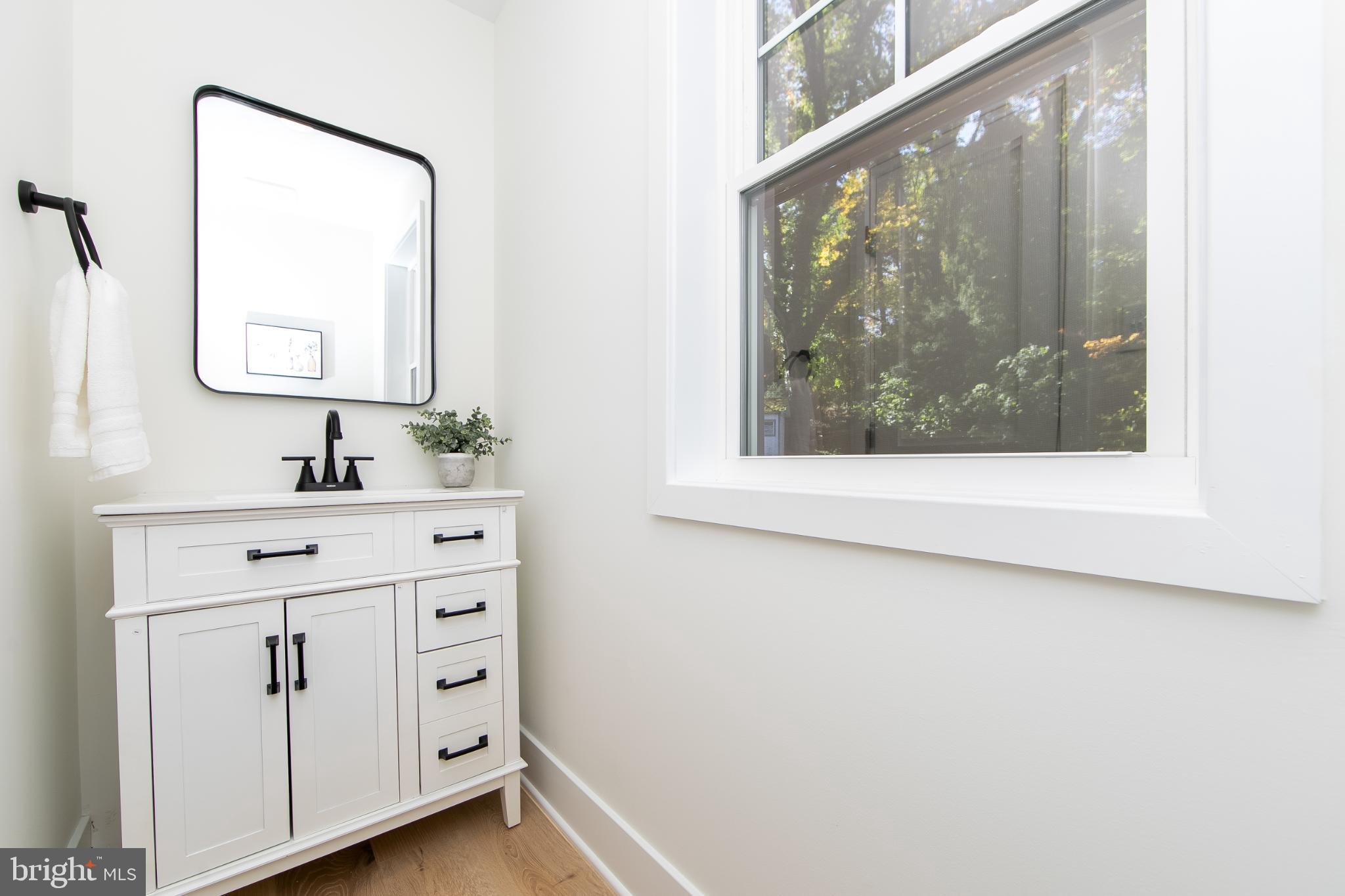 22 Scenic Road Springfield, PA 19064 - Photo 23 of 56 a bathroom with a sink mirror and a window