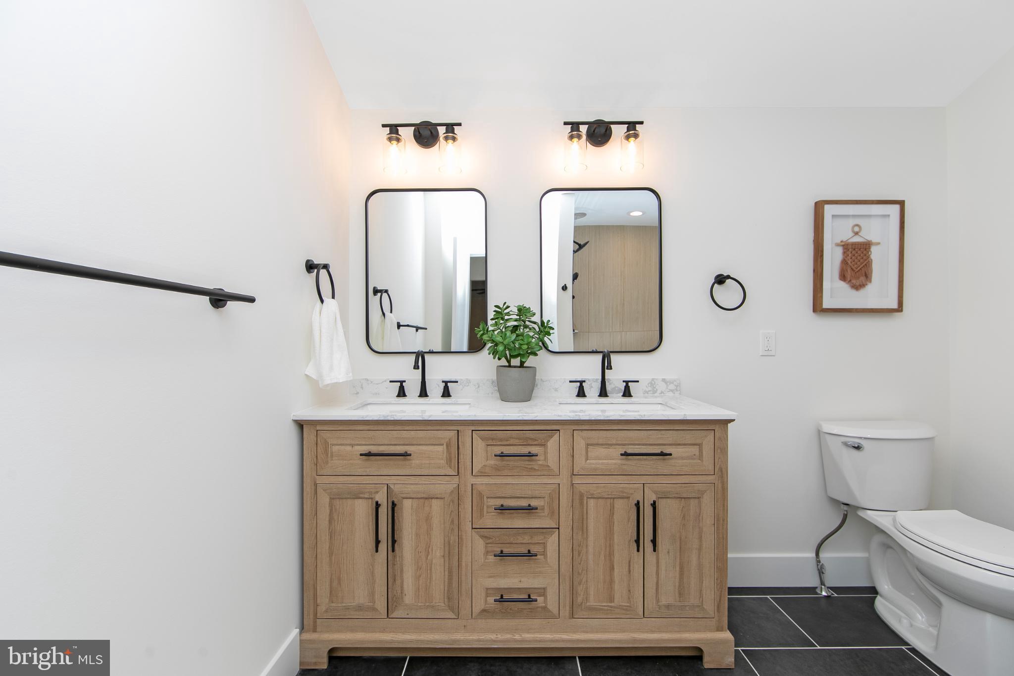 22 Scenic Road Springfield, PA 19064 - Photo 28 of 56 a bathroom with mirror a sink and a toilet