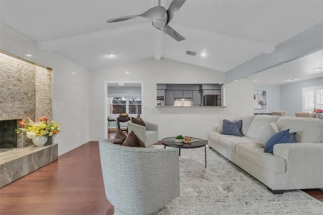 a living room with furniture and potted plant