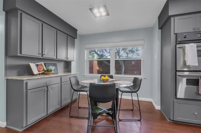 a work place with cabinets and wooden floor
