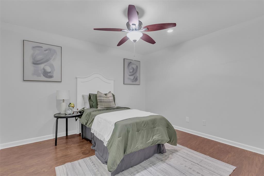 4808 Thunder Road Dallas, TX 75244 - Photo 24 of 39 a bedroom with a bed and a chandelier