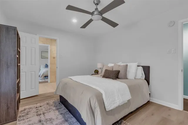 a bedroom with a bed and a ceiling fan