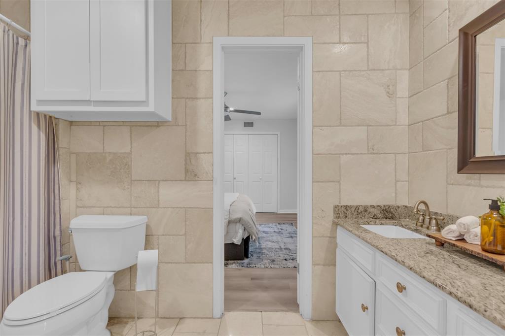 4808 Thunder Road Dallas, TX 75244 - Photo 32 of 39 a bathroom with a granite countertop toilet and sink