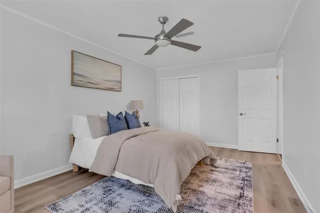 a bed room with a bed and a ceiling fan