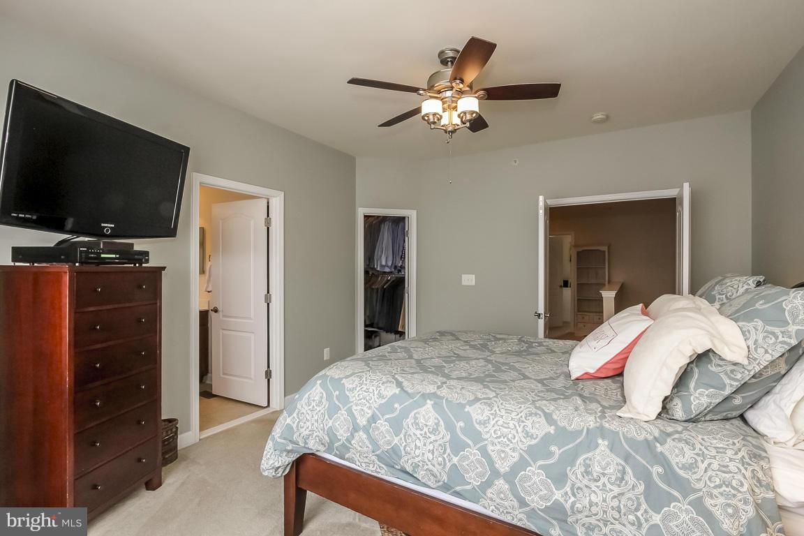 11603 Leesborough Circle Silver Spring, MD 20902 - Photo 15 of 30 a bedroom with a bed and a flat tv screen on dresser