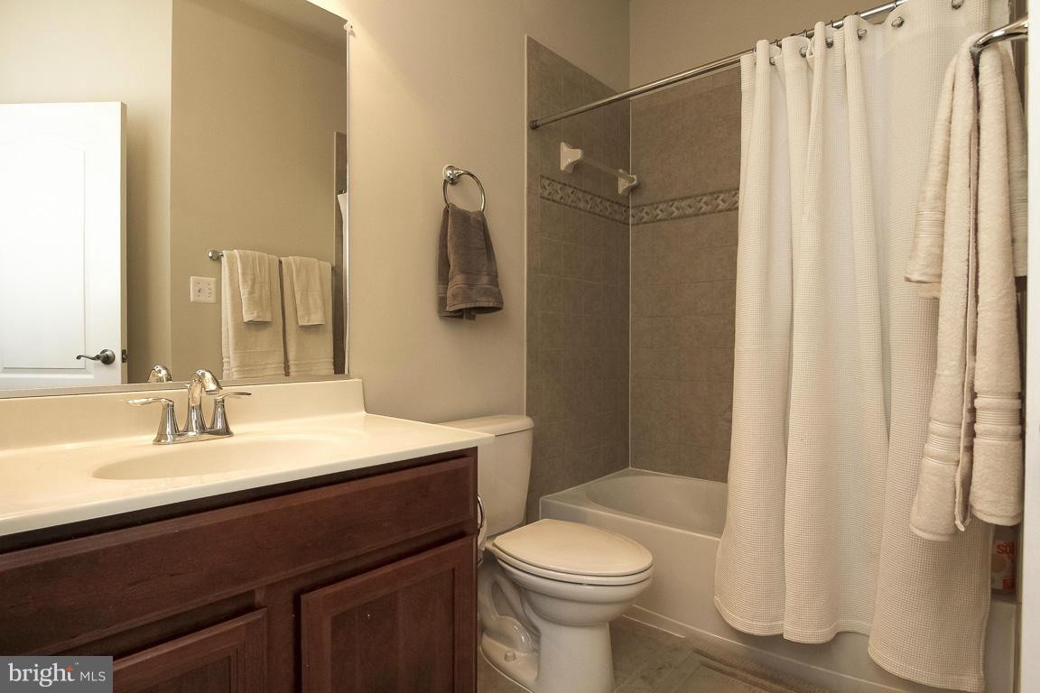 11603 Leesborough Circle Silver Spring, MD 20902 - Photo 20 of 30 a bathroom with a sink a toilet a mirror and shower