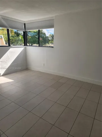 a view of an empty room and a window