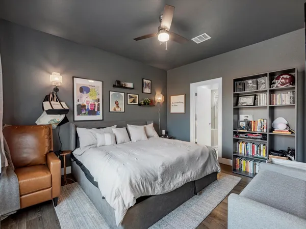 a bedroom with a bed furniture and a book shelf