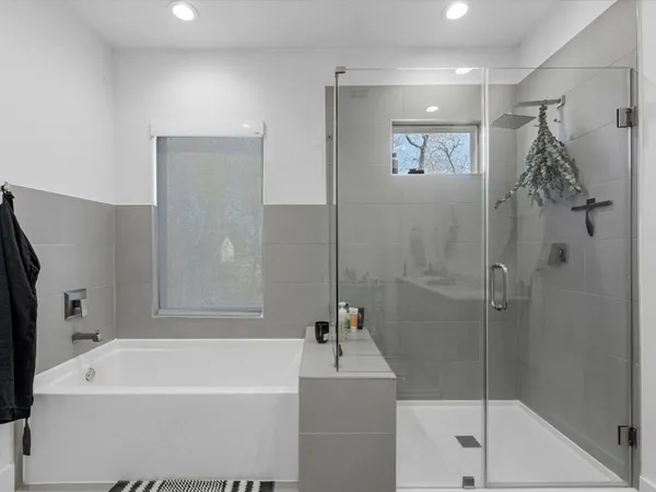 a white bath tub sitting next to a white shower