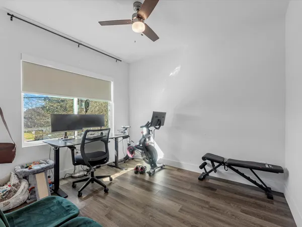 a view of a workspace with furniture and a window