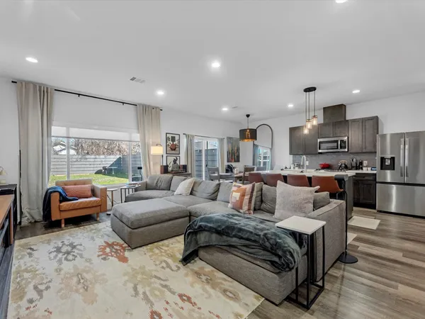 a large living room with furniture and a large window