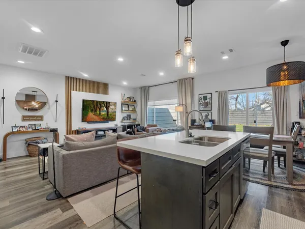 a open kitchen with stainless steel appliances granite countertop a sink a stove and a refrigerator