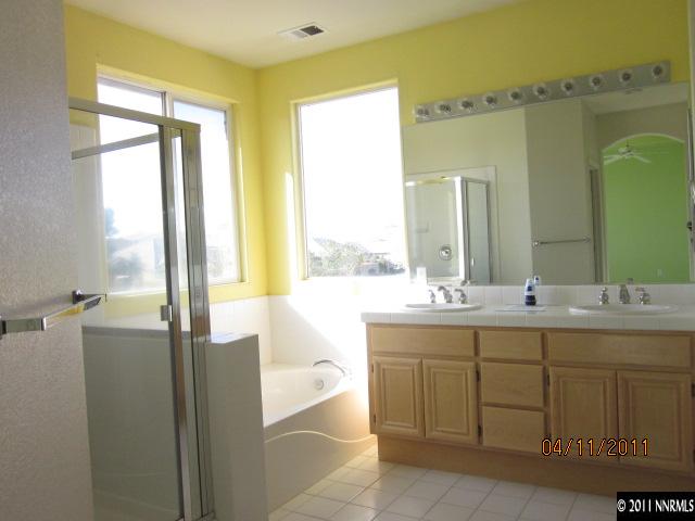 9931 Northrup Drive Reno, NV 89521 - Photo 7 of 8 a bathroom with a double vanity sink and a bathtub