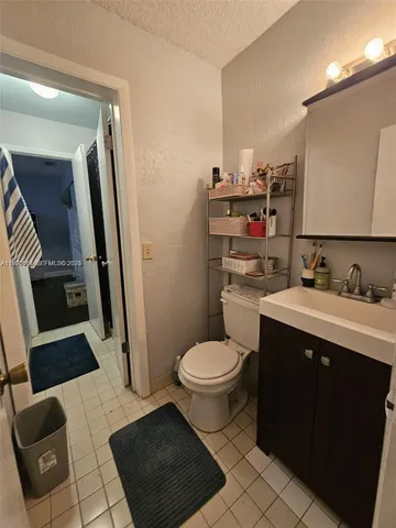 a bathroom with a sink toilet and mirror
