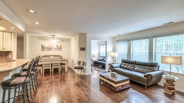 a living room with furniture and wooden floor