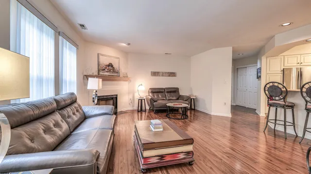 a living room with furniture a fireplace and a large window