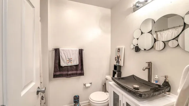 a bathroom with a toilet sink and mirror