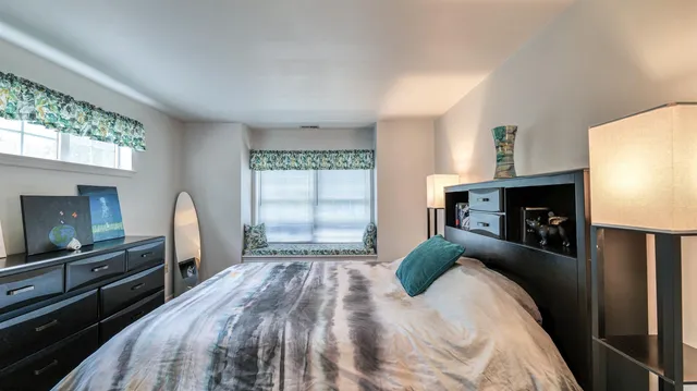 a bedroom with a bed and a fireplace