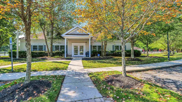 a view of a house with swimming pool and a yard