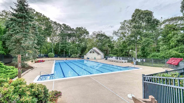 a view of a backyard and basketball ground
