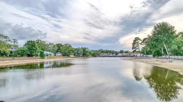 a view of a lake with houses in the back