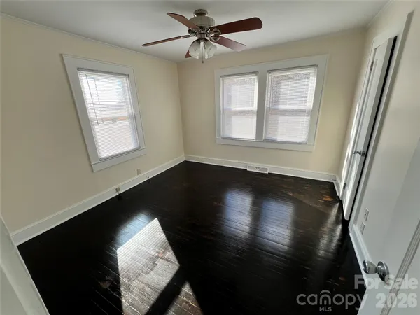 a view of room with window and hardwood floor