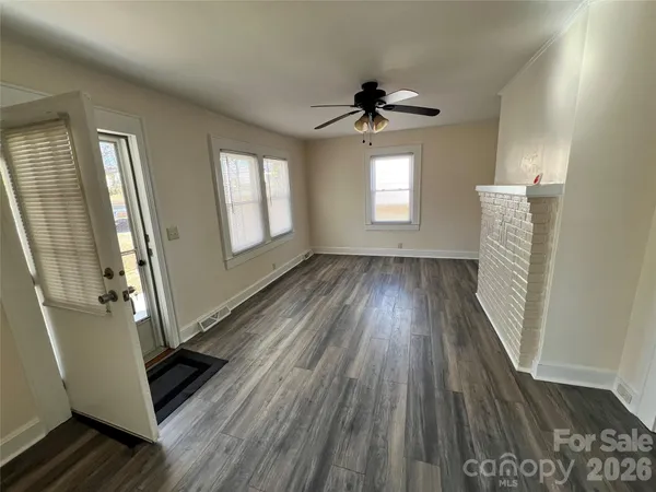 wooden floor in an empty room with a window