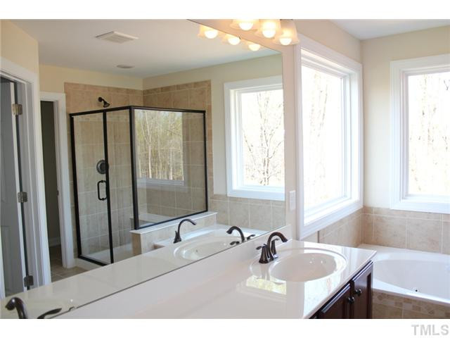 2804 Bending Tree Court Raleigh, NC 27613 - Photo 12 of 25 12x12 Tile Flooring, Custom Stained Cabinets, Cultured Marble Countertop, Oil Rubbed Bronze Fixtures and Hardware! Master Bath/Spa