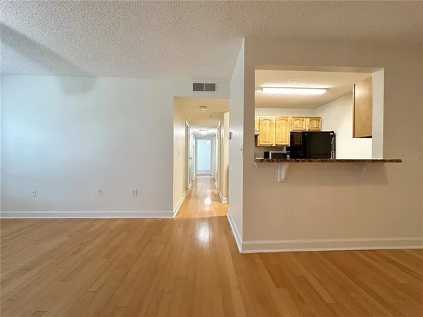 a view of a kitchen with wooden floor and a sink