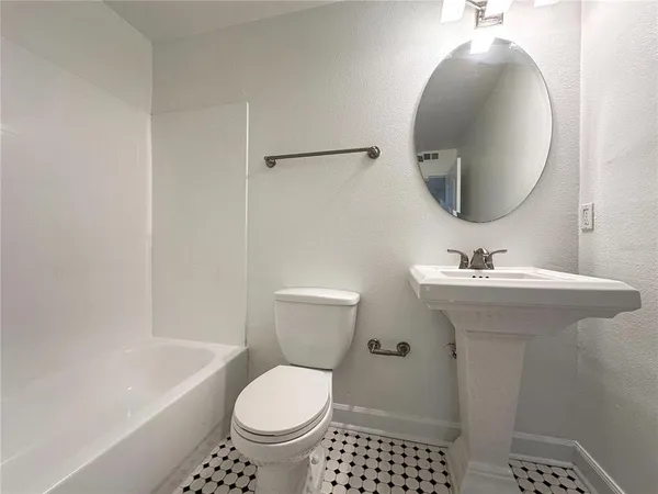 a bathroom with a sink toilet and a bathtub