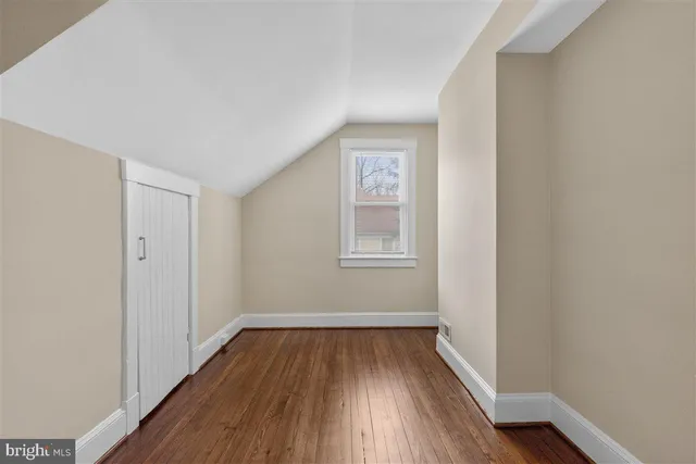 a view of a room with wooden floor and windows