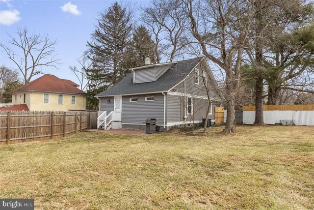 a view of a house with a yard and a tree