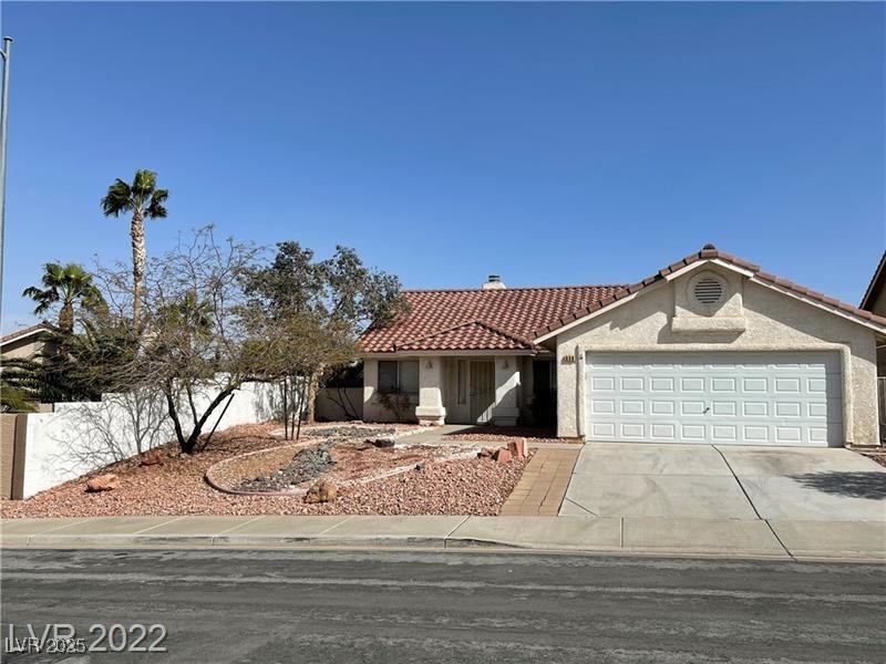 838 Rusty Anchor Way Henderson, NV 89002 - Photo 1 of 18 View of front facade with a tile roof, driveway, stucco siding, a garage, and a chimney