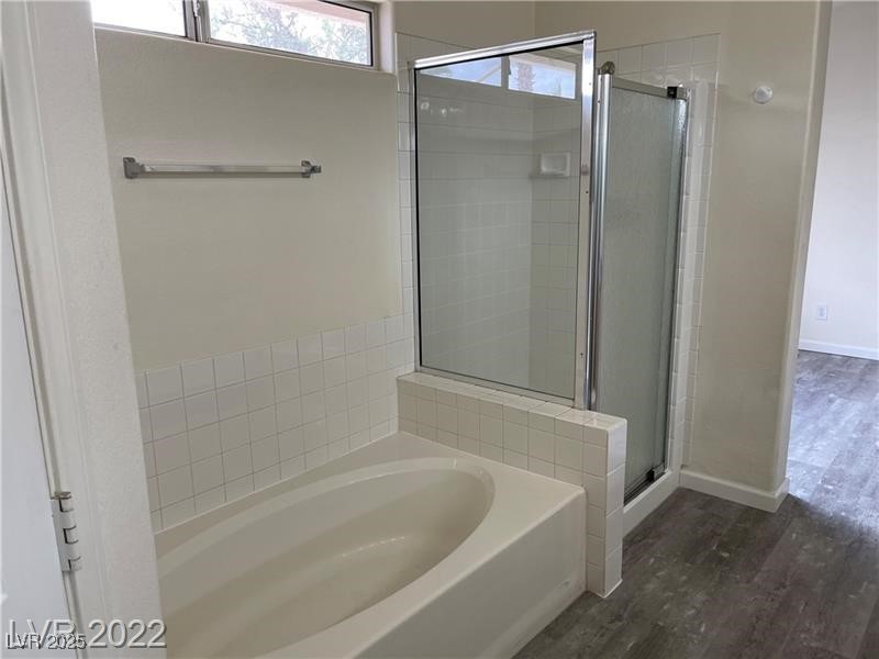 838 Rusty Anchor Way Henderson, NV 89002 - Photo 11 of 18 Full bathroom with a bath, dark wood finished floors, and a shower stall