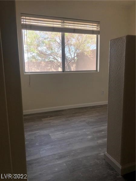 838 Rusty Anchor Way Henderson, NV 89002 - Photo 14 of 18 Unfurnished room featuring dark wood-type flooring and baseboards