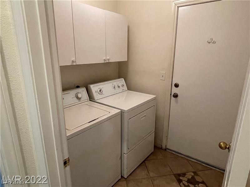 838 Rusty Anchor Way Henderson, NV 89002 - Photo 17 of 18 Washroom featuring light tile patterned flooring, separate washer and dryer, and cabinet space