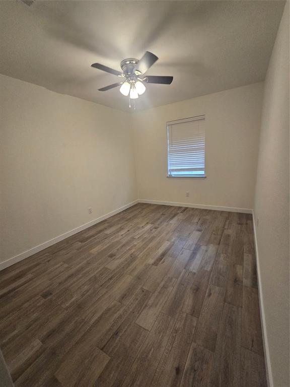 1012 Lynn Street, Unit A Weatherford, TX 76086 - Photo 11 of 15 a view of an empty room with wooden floor and a window
