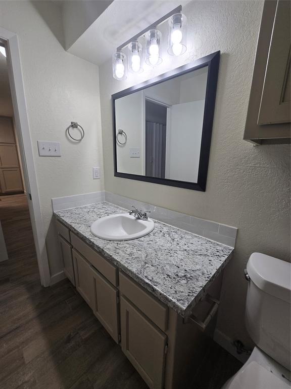1012 Lynn Street, Unit A Weatherford, TX 76086 - Photo 12 of 15 a bathroom with a granite countertop sink and a mirror