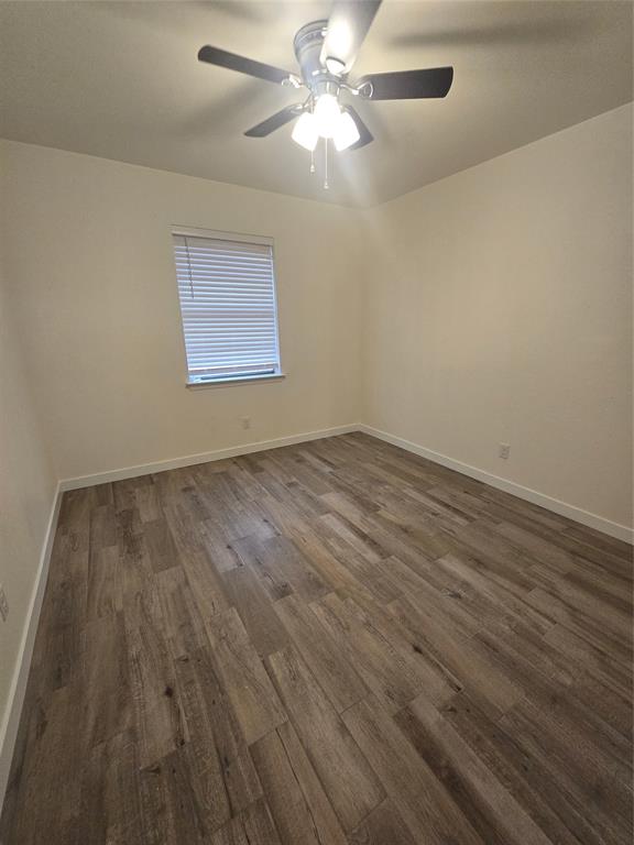 1012 Lynn Street, Unit A Weatherford, TX 76086 - Photo 13 of 15 a view of an empty room with wooden floor and a fan